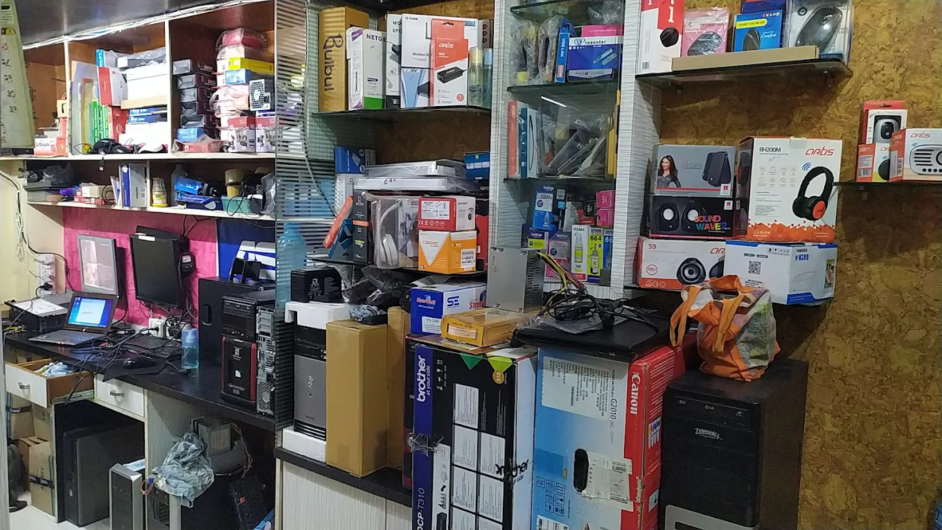Inside Manas Computer & Services Dhule — shelves of laptops, printers, CCTV, networking and accessories